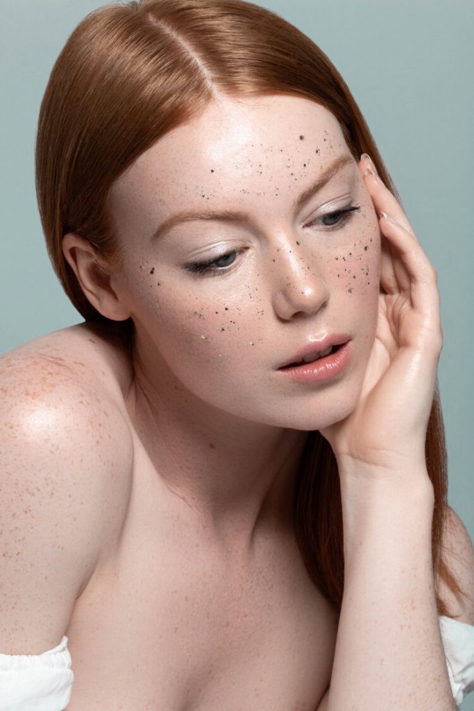 Alexandra Rayne of Devojka Models with glitter on her face.