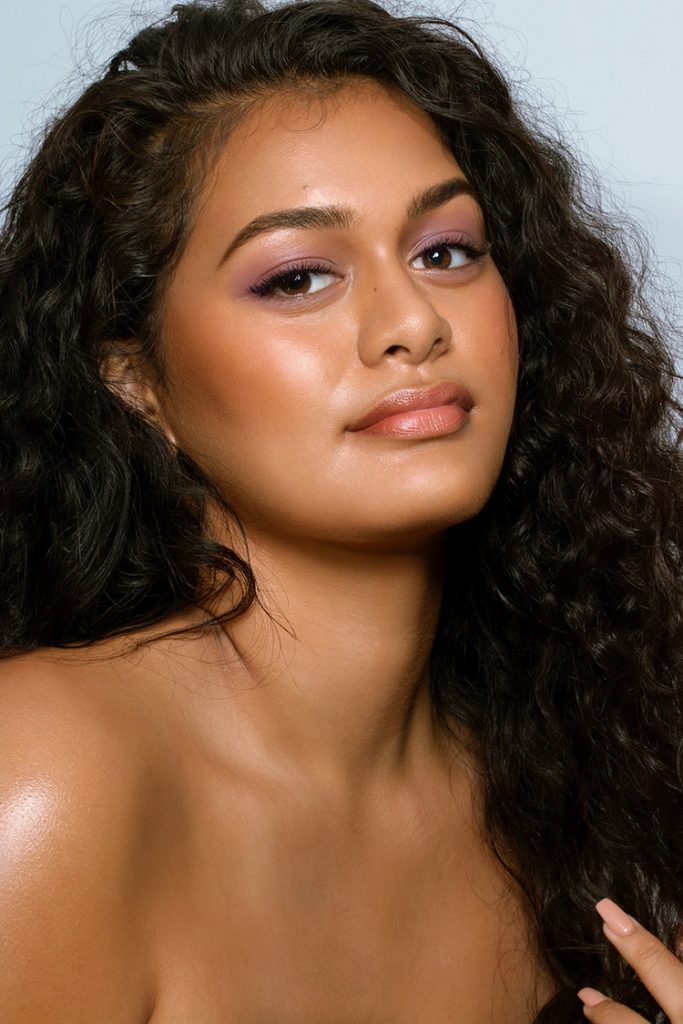 Lateisha Afu with soft purple eyeshadow and glossy skin.