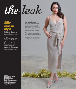 A brunette model wearing a silver dress with a high thigh slit.