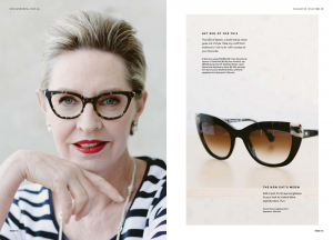 Close up on a mature model wearing tortoise shell sunglasses and red lipstick.